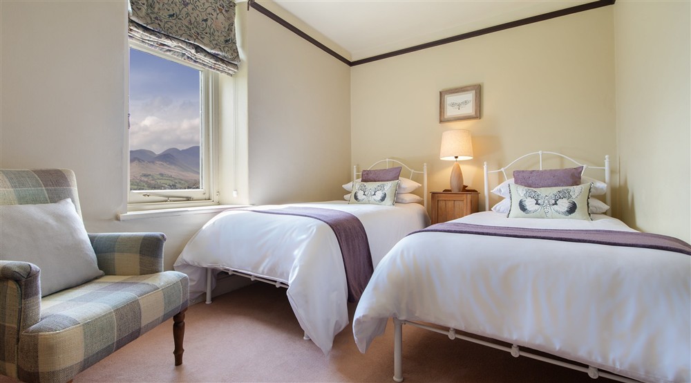 The second floor twin bedroom with views towards the Derwent Fells at Millbeck Towers in Keswick, Cumbria