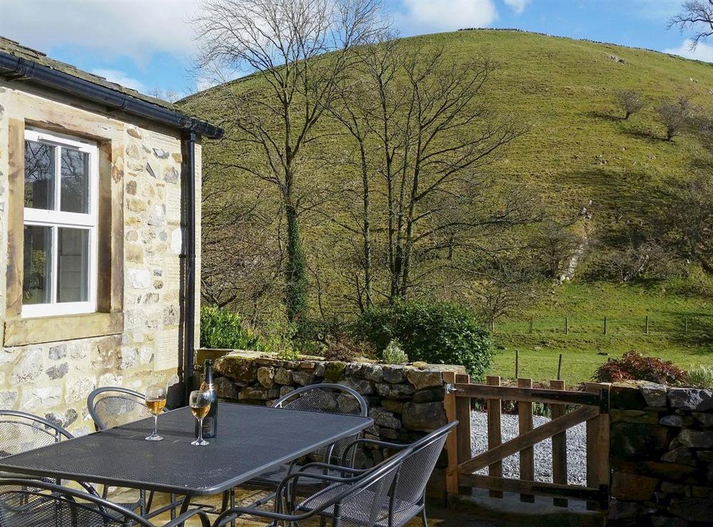 Enclosed patio with garden furniture at Miller Cottage in Scalegill, near Kirkby Malham, North Yorkshire