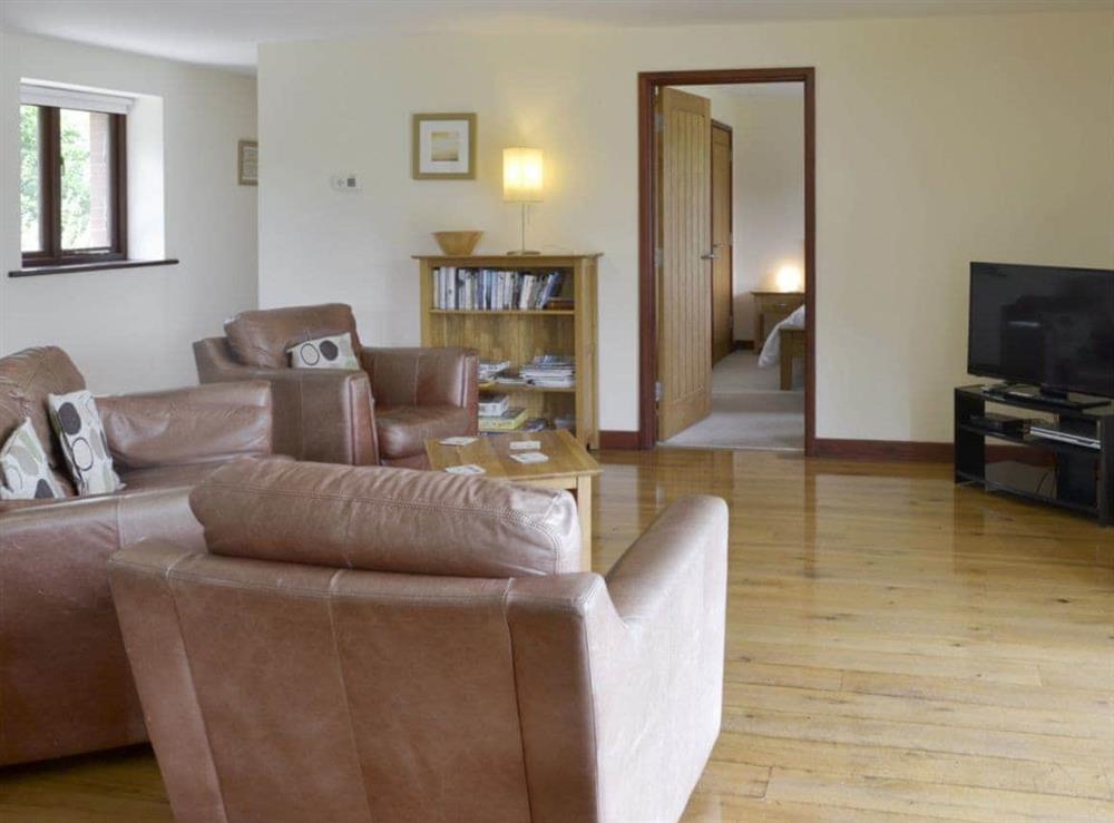 Spacious open-plan living space with wooden floor at Millers Rest in Poundstock, Bude, Cornwall
