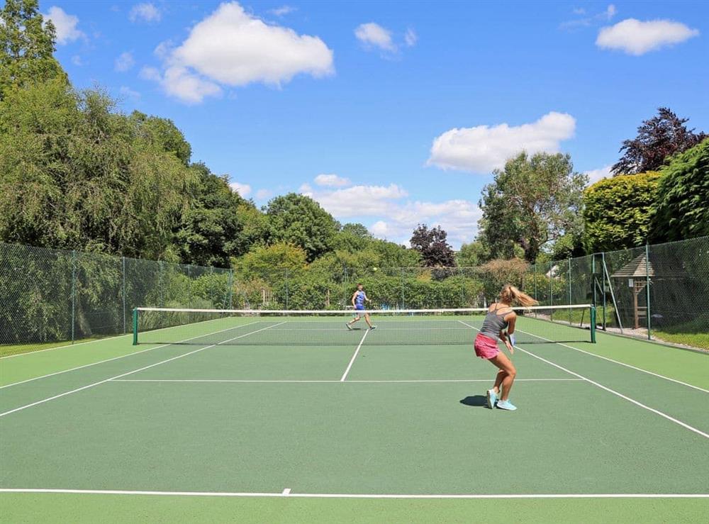 Tennis court at Miller’s Thumb in Bow Creek, Nr Totnes, South Devon., Great Britain