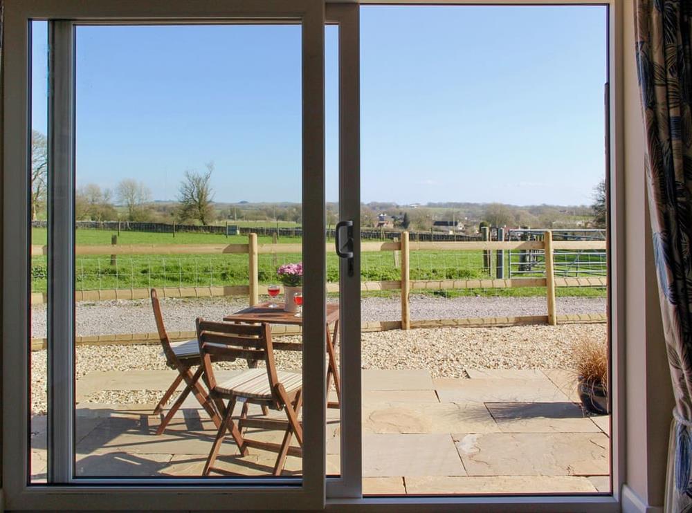 Patio door offering access to the patio area at Millstone Barn in Priddy, near Wells, Somerset