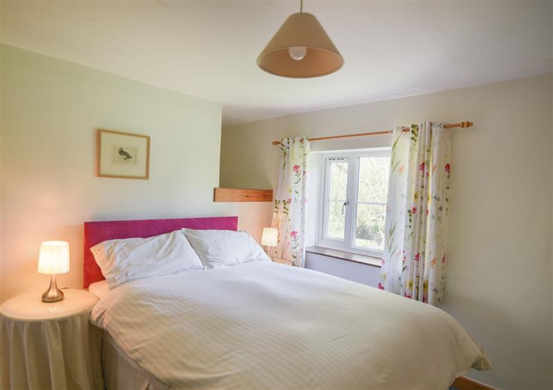 A bedroom in Millwater Cottage at Millwater Cottage, Dalwood