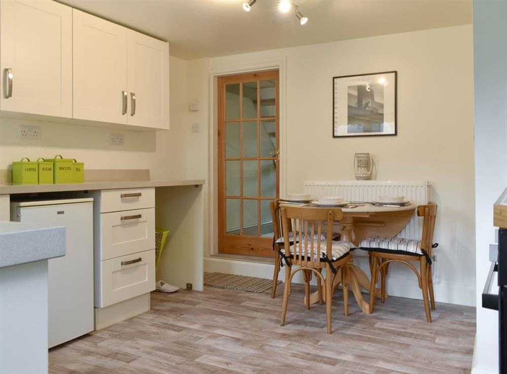 Fully equipped kitchen with dining area at Millys Nook in St Austell, Cornwall