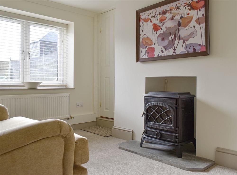 Welcoming living room with wood burner at Millys Nook in St Austell, Cornwall