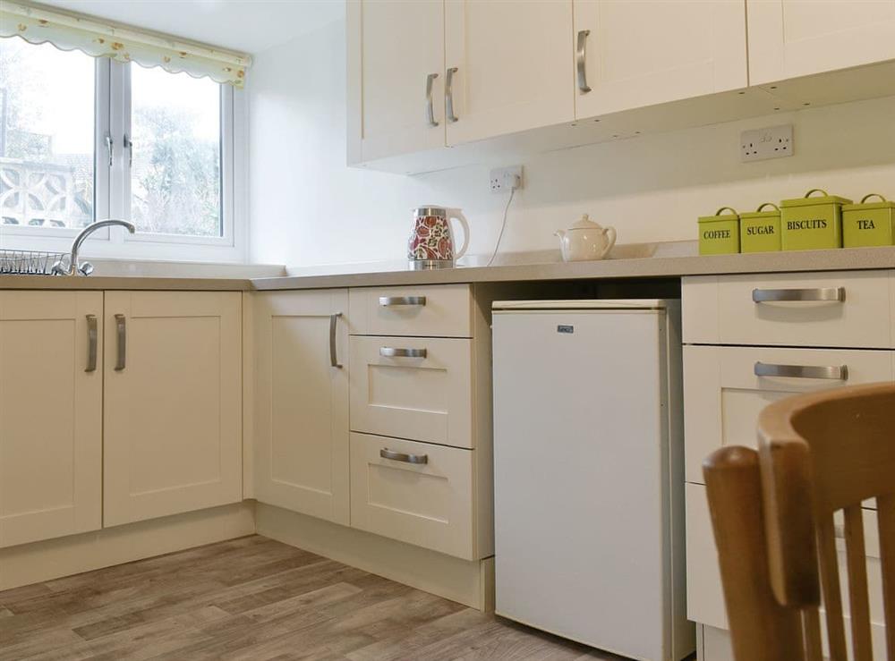 Well-equipped fitted kitchen and dining room at Millys Nook in St Austell, Cornwall