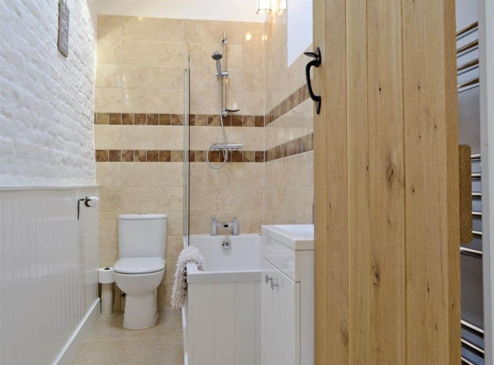 Bathroom with shower over bath at The Old Forge, 