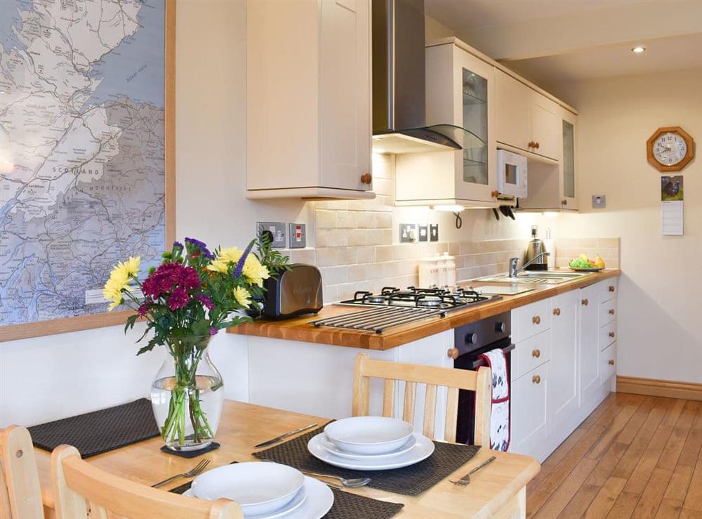 Dining and adjacent kitchen area at River Cottage, 