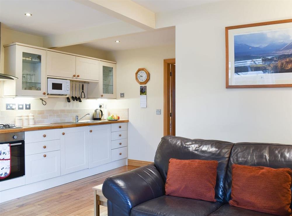 Generous living space with cosy leather furniture at River Cottage, 