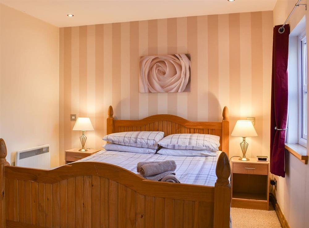 Welcoming bedroom with pine bed at River Cottage, 