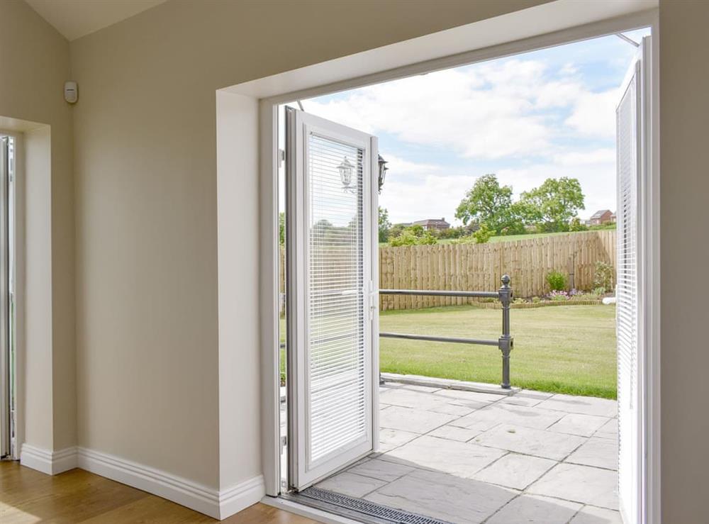 Living area with patio doors to rear garden at Miners Meadow in Wheatley Hill, Durham, England