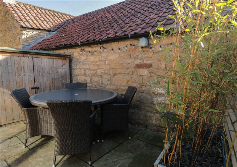 Enjoy a glass of wine on the patio at Minns Cottage, Snainton