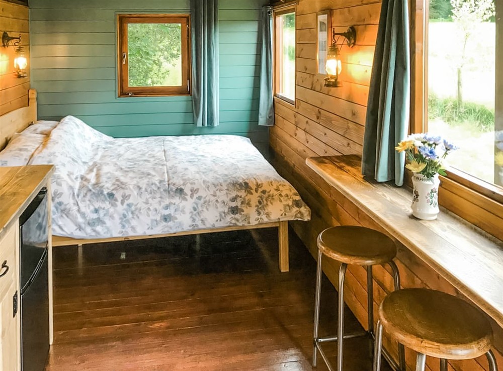 Open plan living space at Misty Shepherds Hut in Aberporth, Dyfed