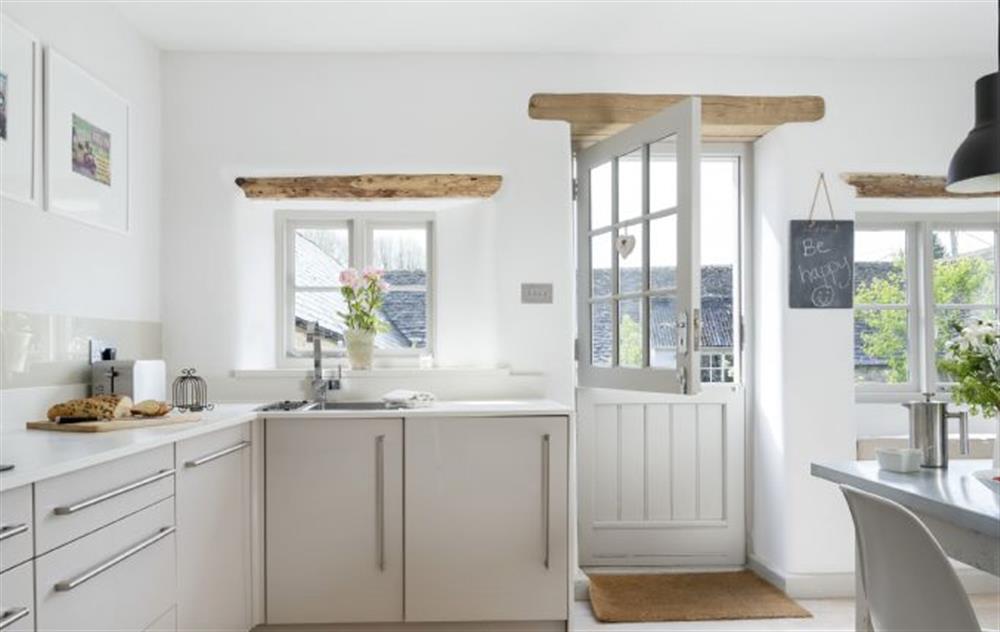 The kitchen/dining room has a stable door which opens out onto the south facing walled garden at Mole End Cottage, North Cerney
