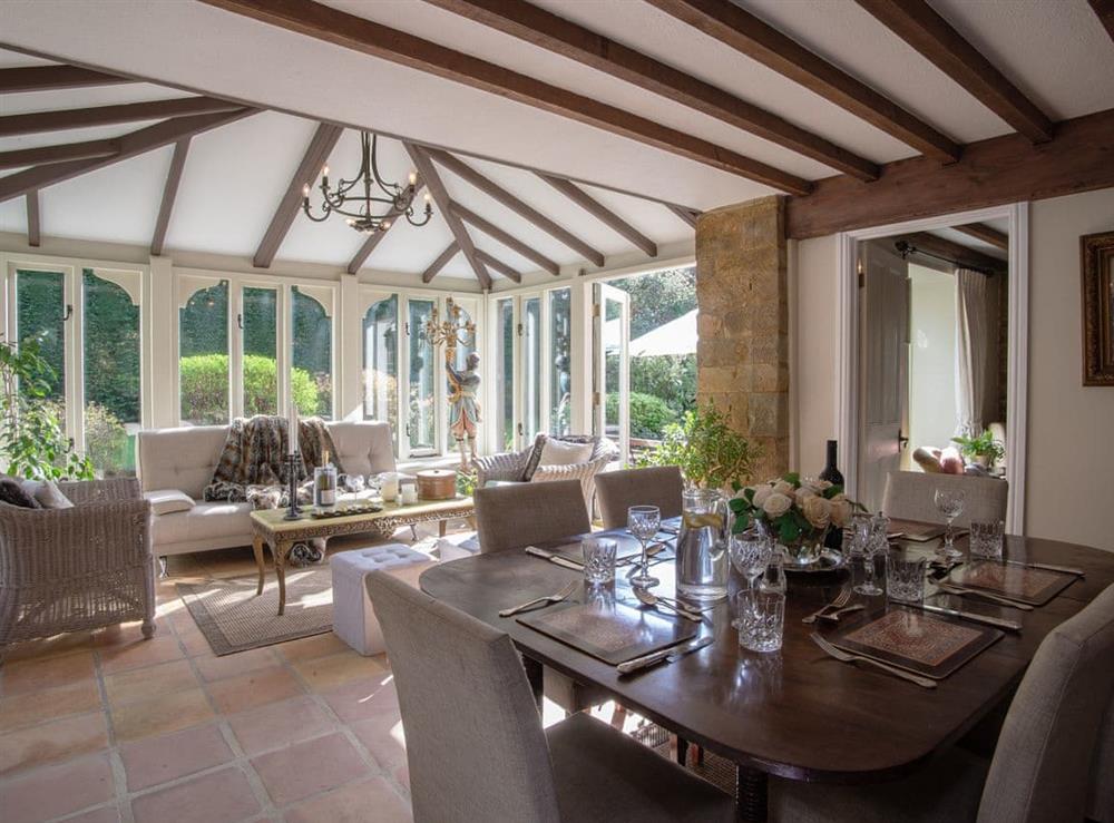Conservatory with dining area at Monastery Barn in Shutford, near Banbury, Oxfordshire