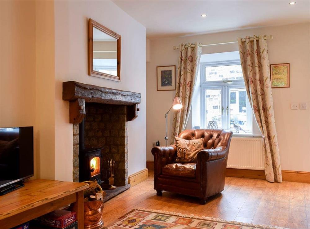 Open plan living space with wood burner at Monkey Cottage in Grassington, North Yorkshire