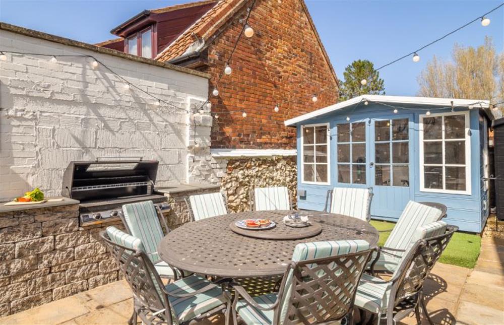 Outside: Entertaining area with seating, bar and barbecue at Monkey Puzzle Cottage, Snettisham near Kings Lynn