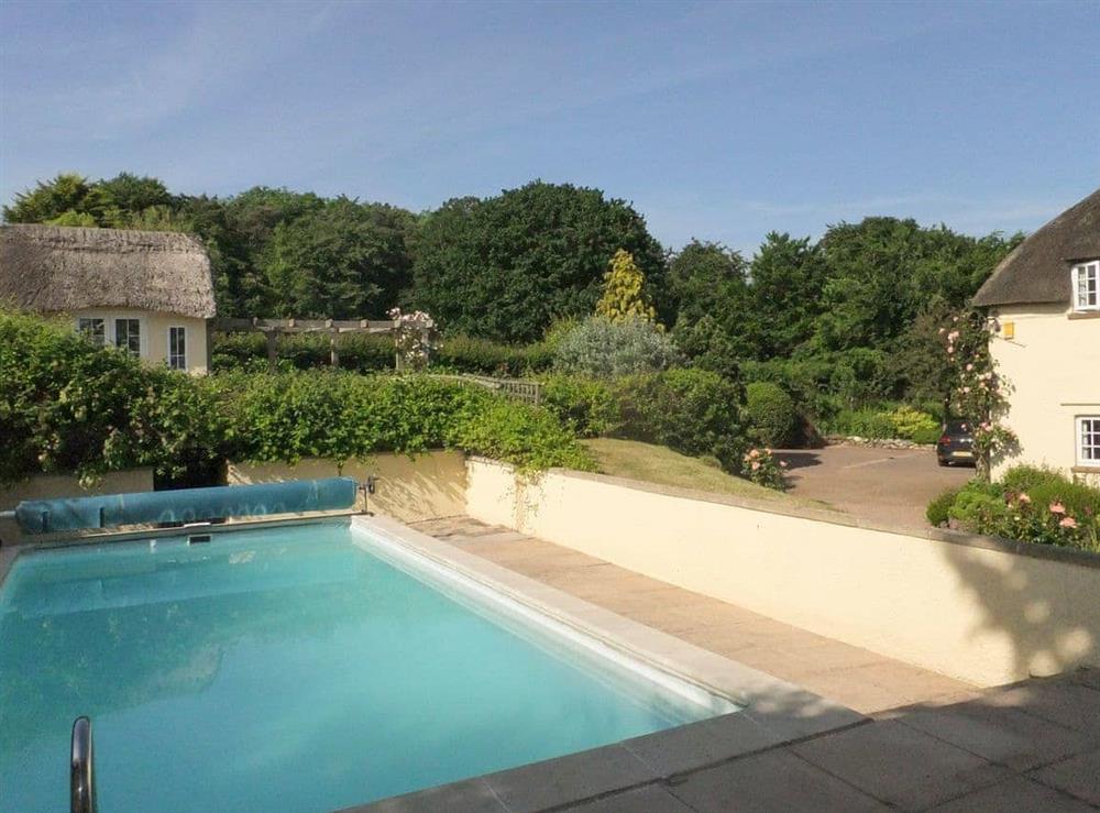 Outdoor swimming pool at Monks Thatch Cottage in Otterton, East Devon., Great Britain