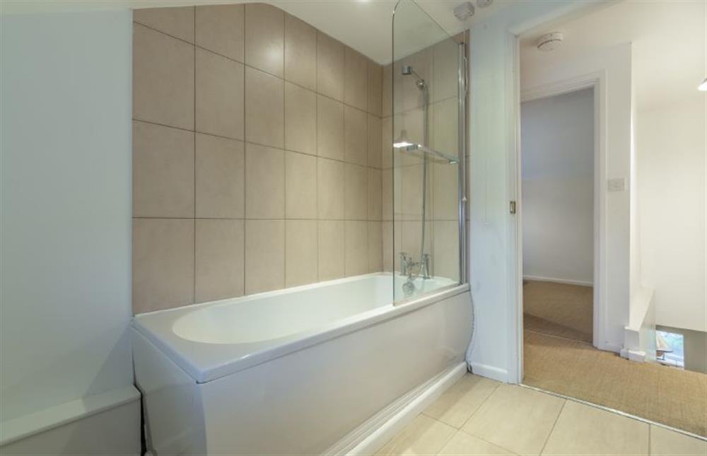 First floor: Family bathroom features a bath with shower over at Montgomery Cottage, Docking near Kings Lynn