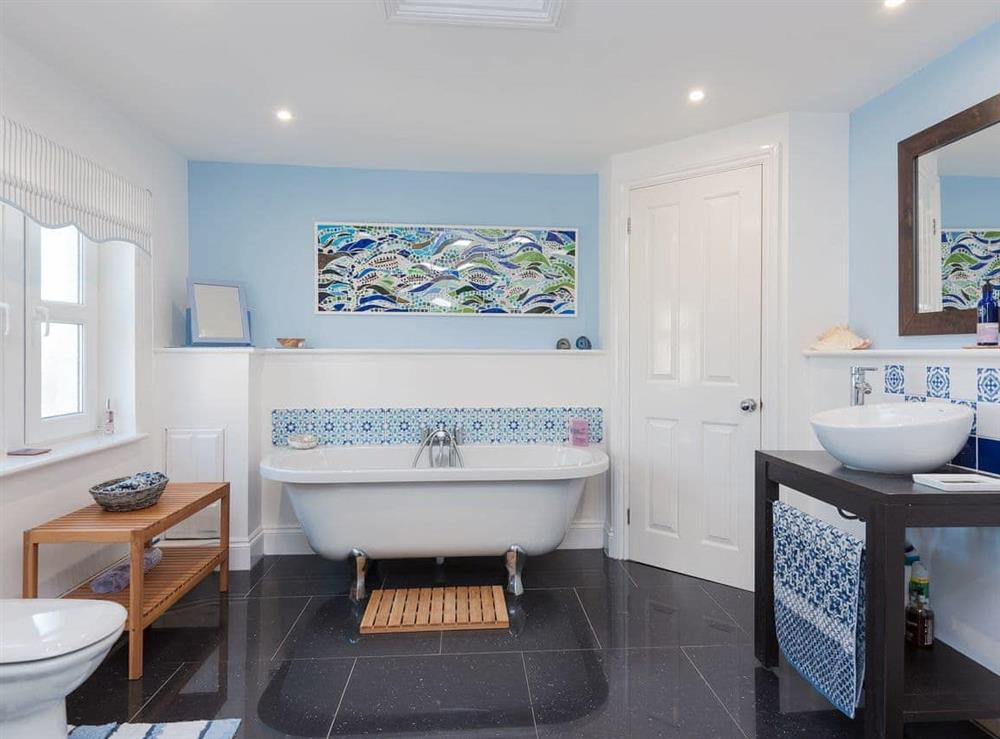 Family bathroom with free-standing bath and separate shower cubicle at Moonbeam House in Freshwater Bay, Isle of Wight
