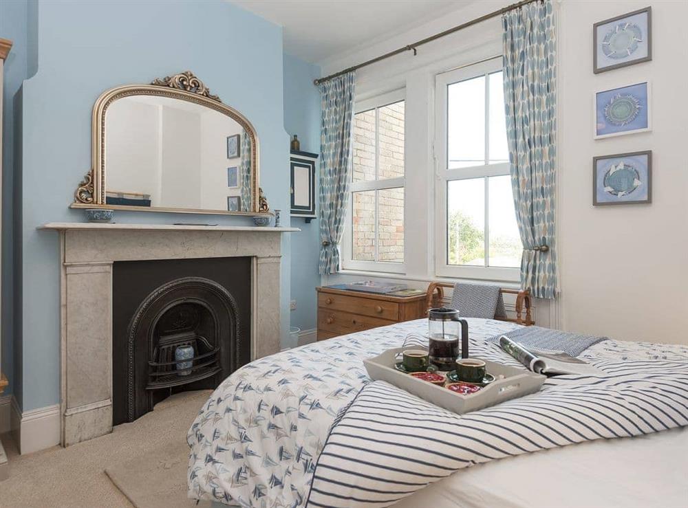 Feature fireplace within double bedroom at Moonbeam House in Freshwater Bay, Isle of Wight