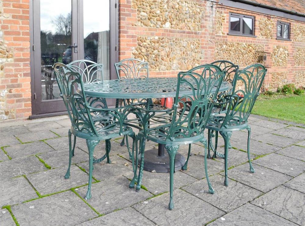 Paved patio with outdoor furniture at Baileys Barn, 