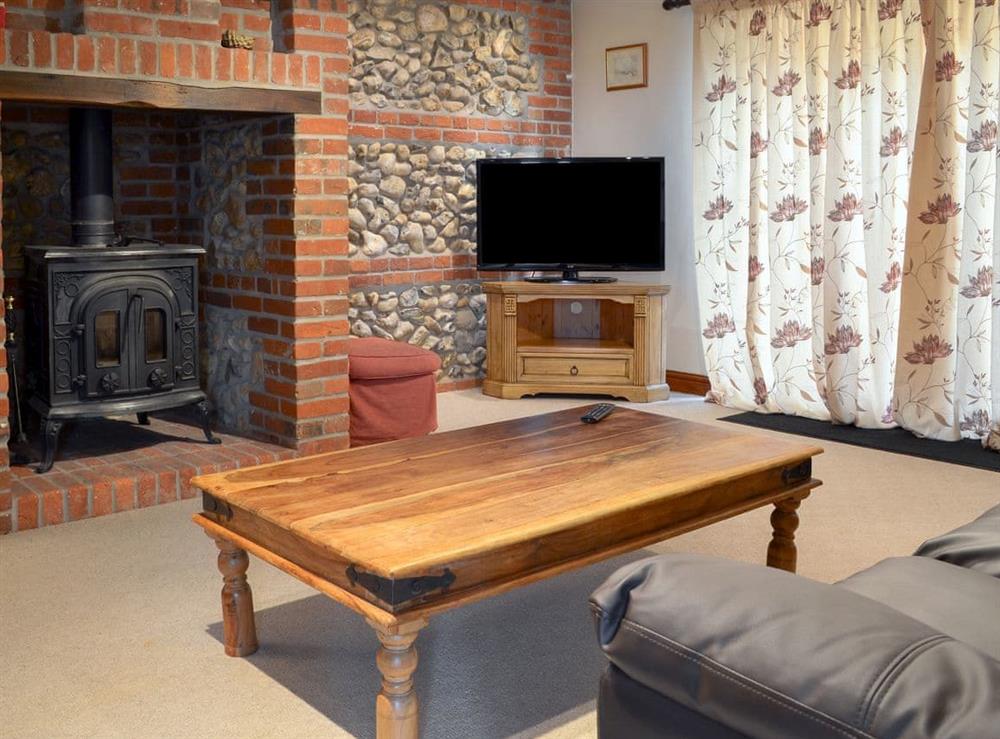Delightful living room with wood burner at Church Farm Barn, 