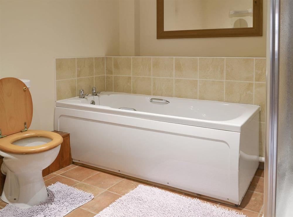 Family bathroom with bath and separate shower cubicle at Dairy Cottage, 