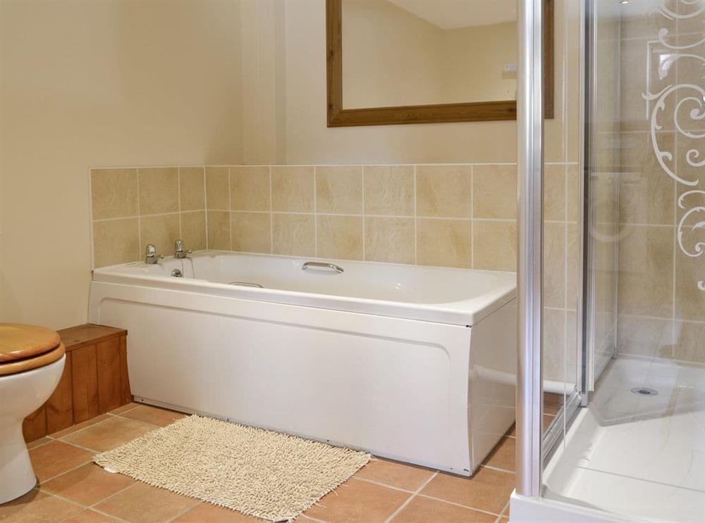 Bathroom with bath and separate shower cubicle at Pond Cottage, 