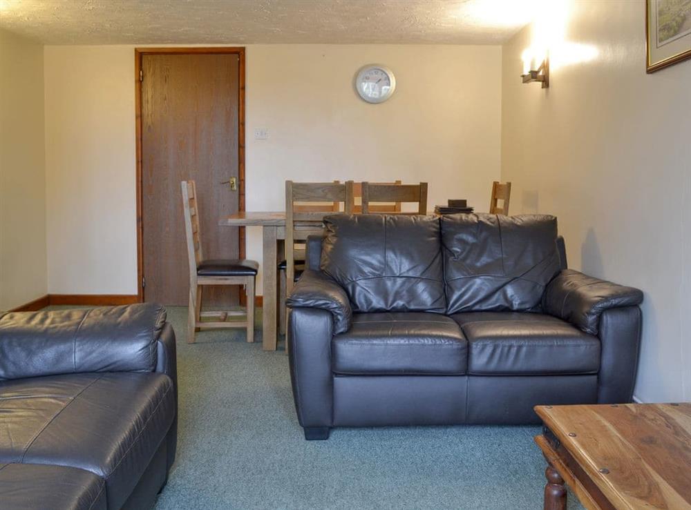 Spacious living area with convenient dining area at Stable Cottage 6, 