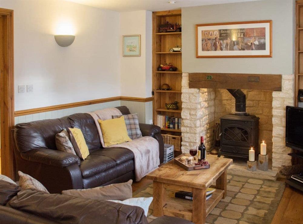 Lovely living room with woodburning sove at Moorhens Cottage in Cotswold Water Parks, Glos., Gloucestershire