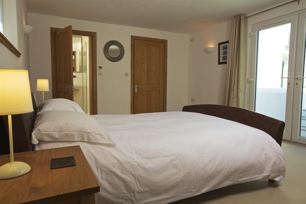 Spacious master bedroom with doors out to private rear garden at Moorings in East Portlem'th, Salcombe