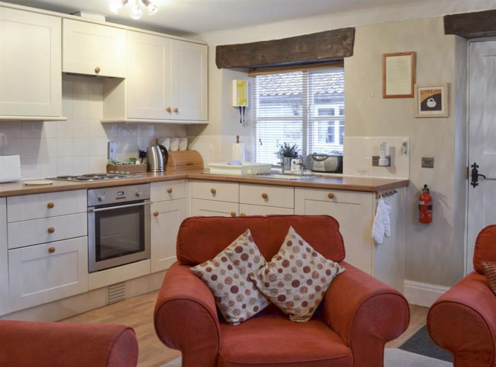Fully-equipped fitted kitchen within an open-plan designed room at Moorland Cottage in Hutton-le-Hole, near Kirkbymoorside, North Yorkshire