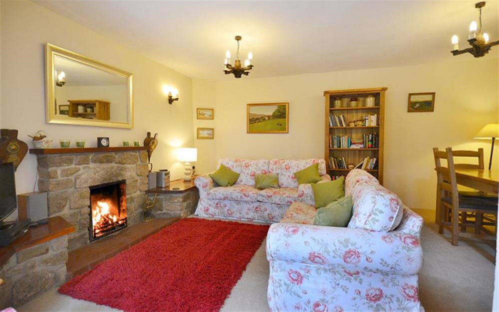 Enjoy the cosy sitting area and warmth from the open fire. at Moorlands Cottage in Belstone