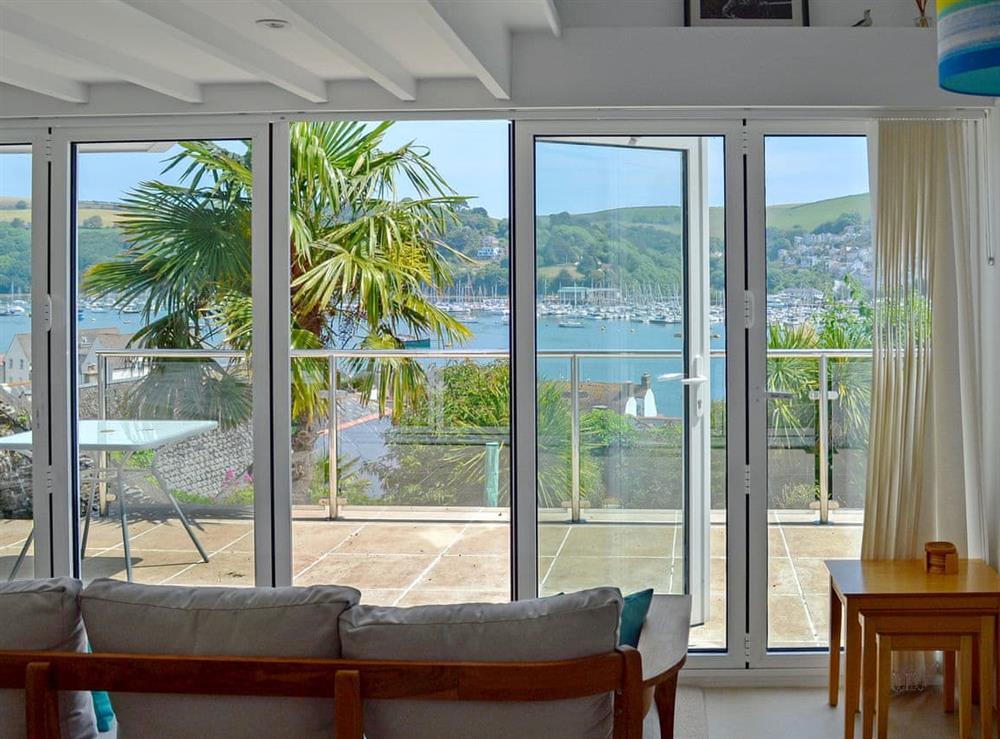 Living room located in an elevated position with stunning views over the river, across to Kingswear and out to sea at Morning Sun, Above Town 47 in Dartmouth, Devon