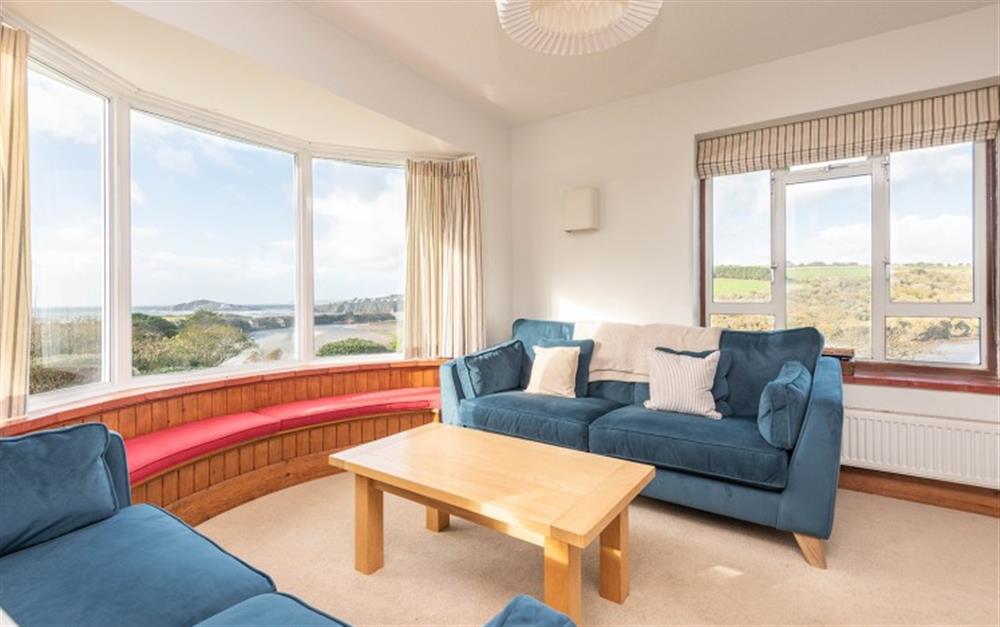 The sitting room with dual aspect windows of the estuary and Burgh Island at Morstones in Bantham