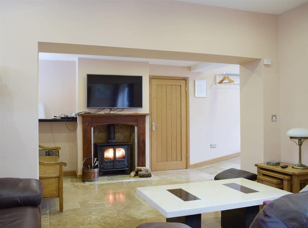 Stylish living area with wood burner at Morton Grange Coach House in Ellesmere, Shropshire