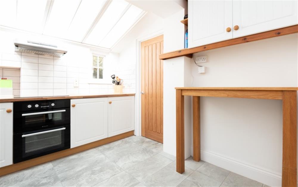 Kitchen with concealed utility room behind the side door  at Morwenna in Polperro