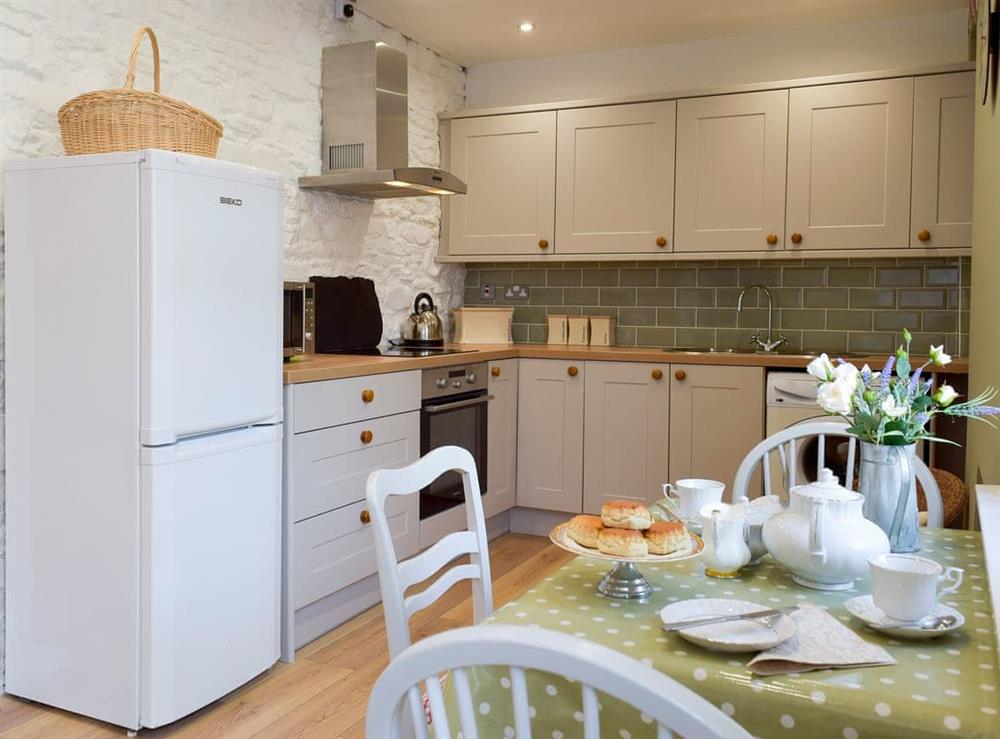 Galley style kitchen with breakfast bar (photo 2) at Moss Cottage in Burry Port, near Llanelli, Carmarthenshire, Dyfed