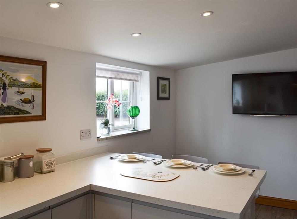 Kitchen with breakfast bar (photo 2) at Moss Hall Barn in Rushton, near Tarporley, Cheshire