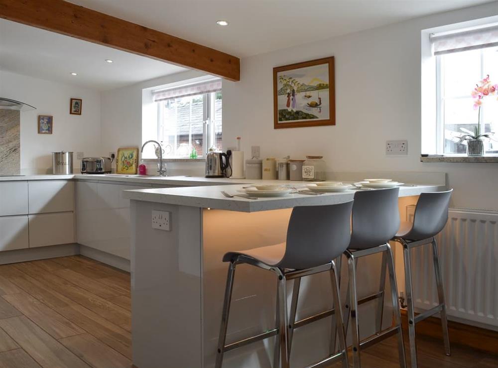 Kitchen with breakfast bar at Moss Hall Barn in Rushton, near Tarporley, Cheshire