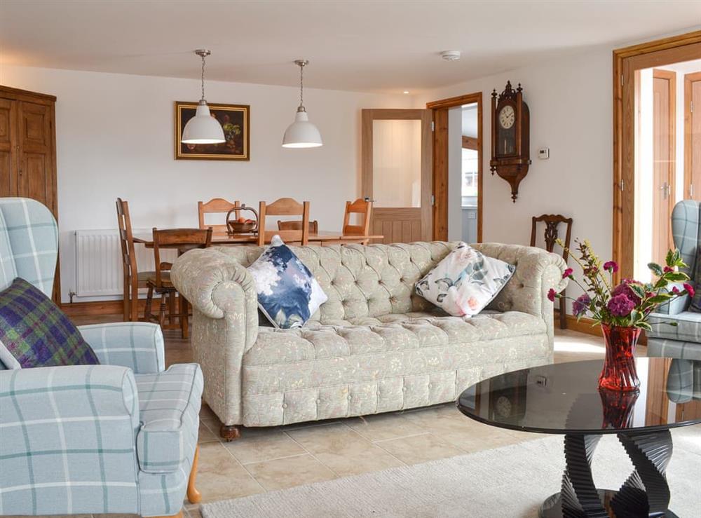 Living room with dining area at Moss Hall Barn in Rushton, near Tarporley, Cheshire