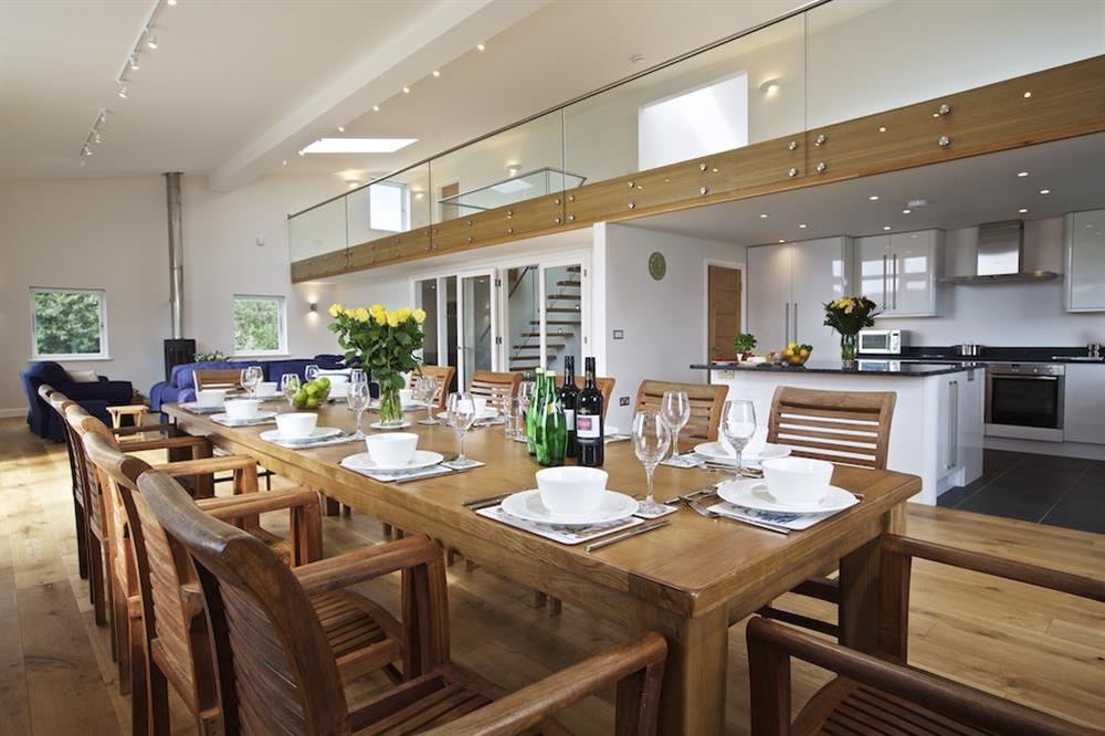 Long wooden dining table seating twelve guests comfortably at Moult Hill Barn in , Salcombe