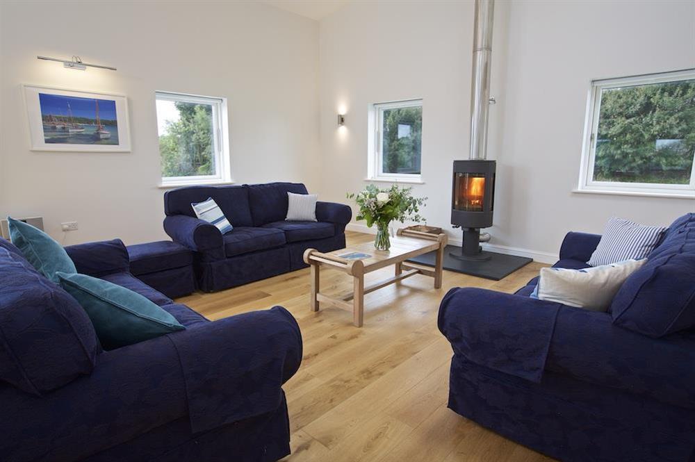 Spacious living area with four double sofas and wood-burning stove at Moult Hill Barn in , Salcombe