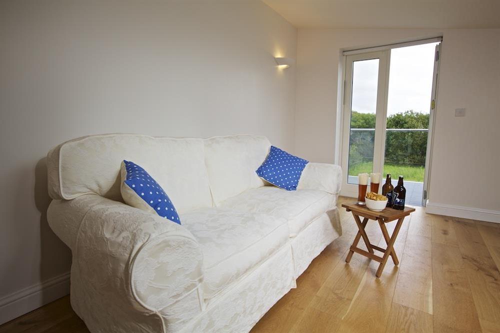 Very spacious mezzanine level with large sofa and door out to balcony at Moult Hill Barn in , Salcombe