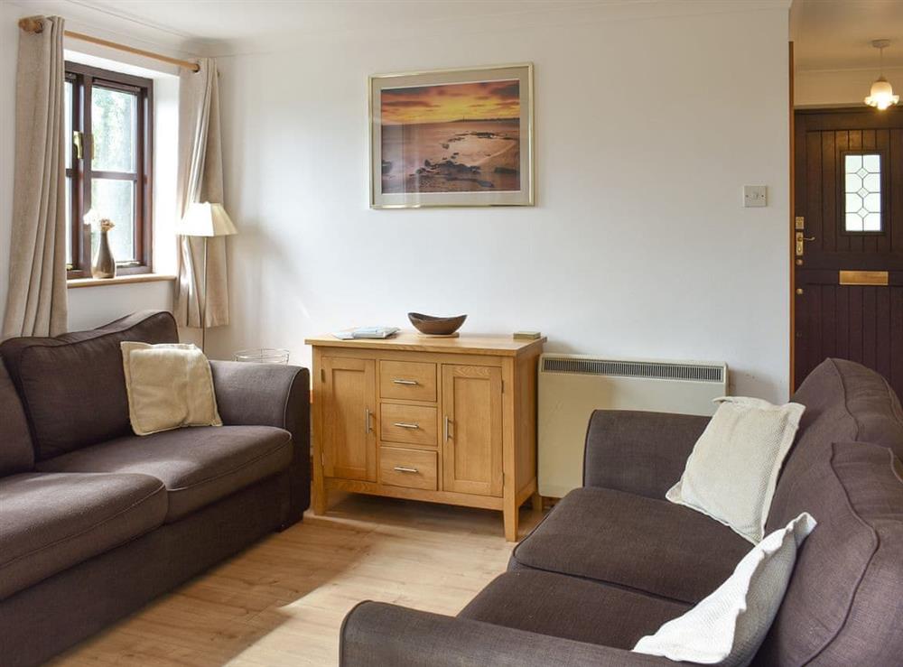 Comfortable seating within living area at Prince Croft Cottage, 