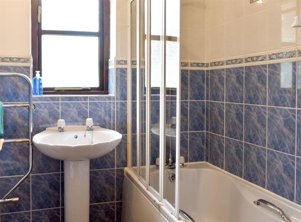 Family bathroom with shower over bath at Prince Croft Cottage, 