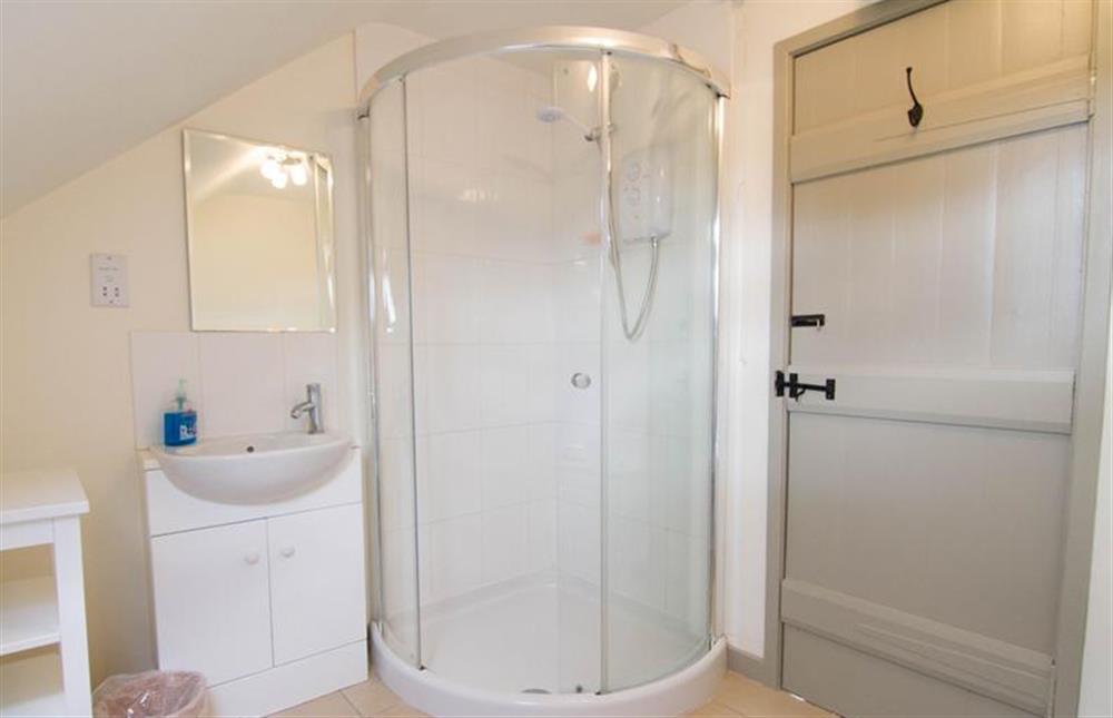First floor: The family bathroom has bath and separate shower at Mow Creek Cottage, Brancaster Staithe near Kings Lynn