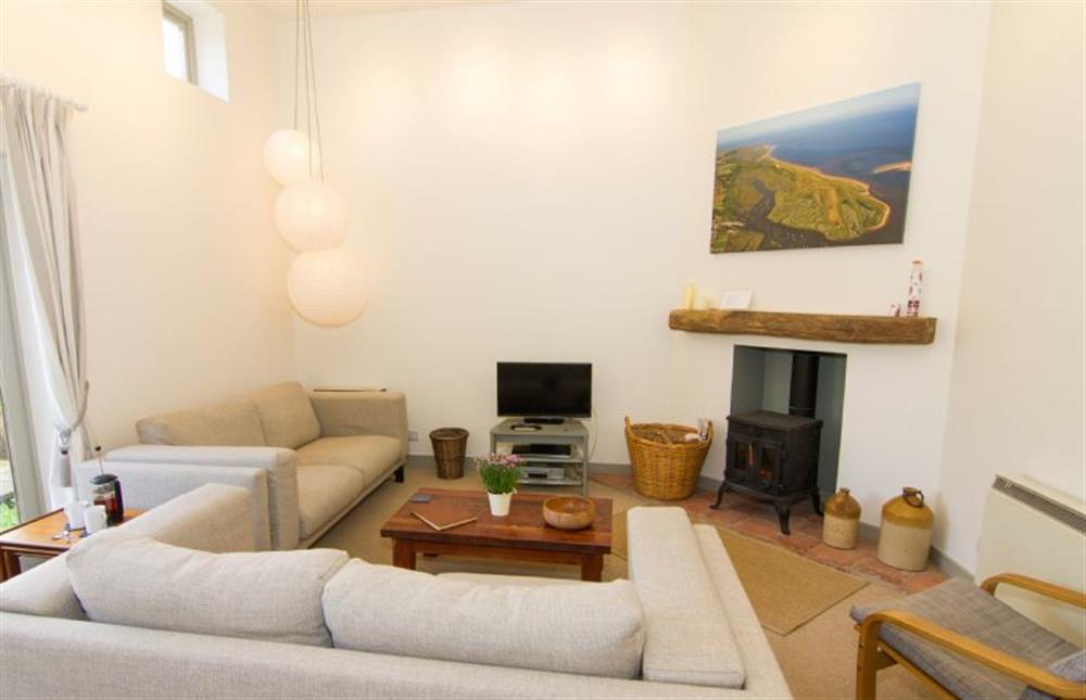 Lower ground floor: Bright sitting room with access to garden at Mow Creek Cottage, Brancaster Staithe near Kings Lynn