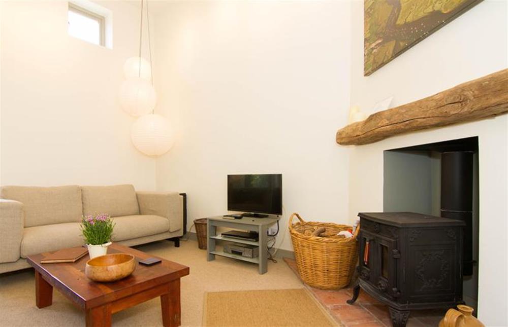 Lower ground floor: The sitting room has cosy wood burning stove at Mow Creek Cottage, Brancaster Staithe near Kings Lynn