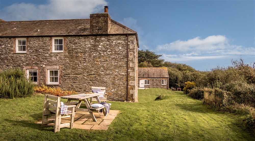 The exterior of Mowhay and the shared garden, with lawn and outdoor dining furniture, Cornwall at Mowhay in Truro, Cornwall